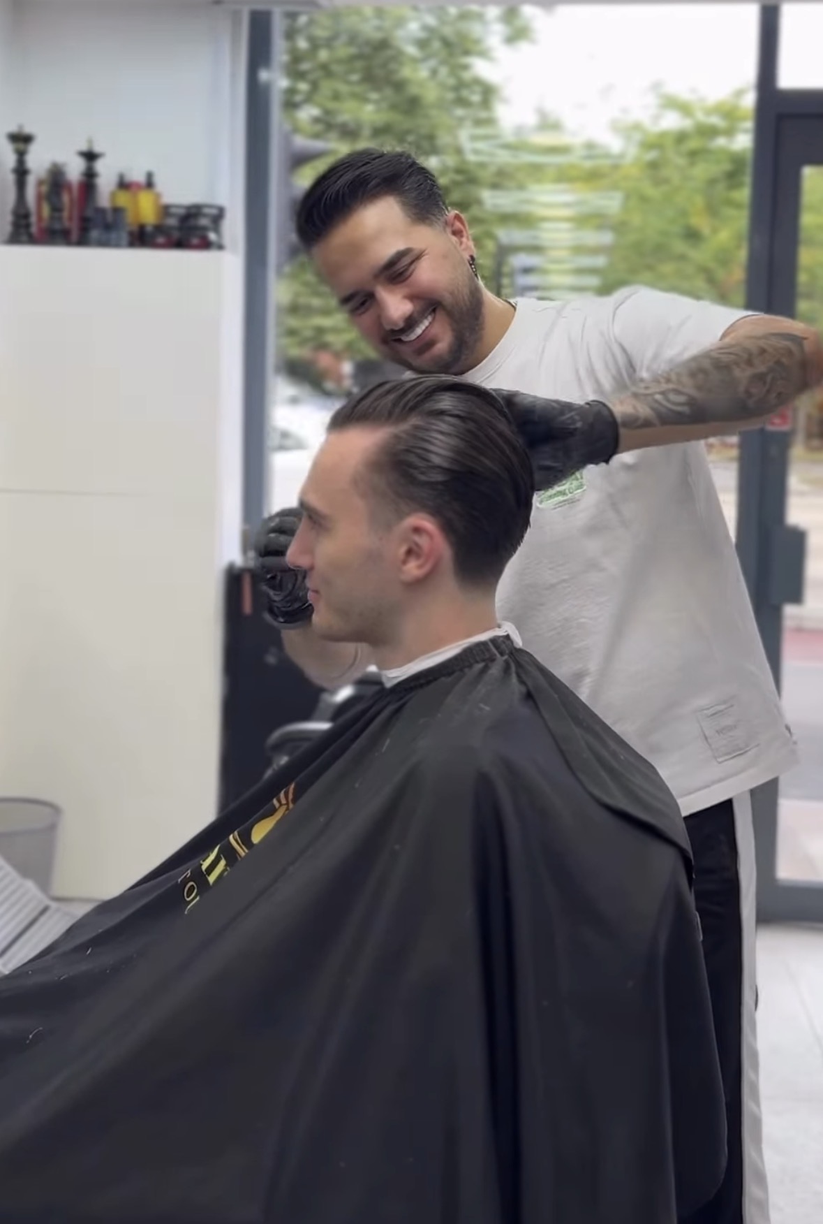 Ben styling a client's hair